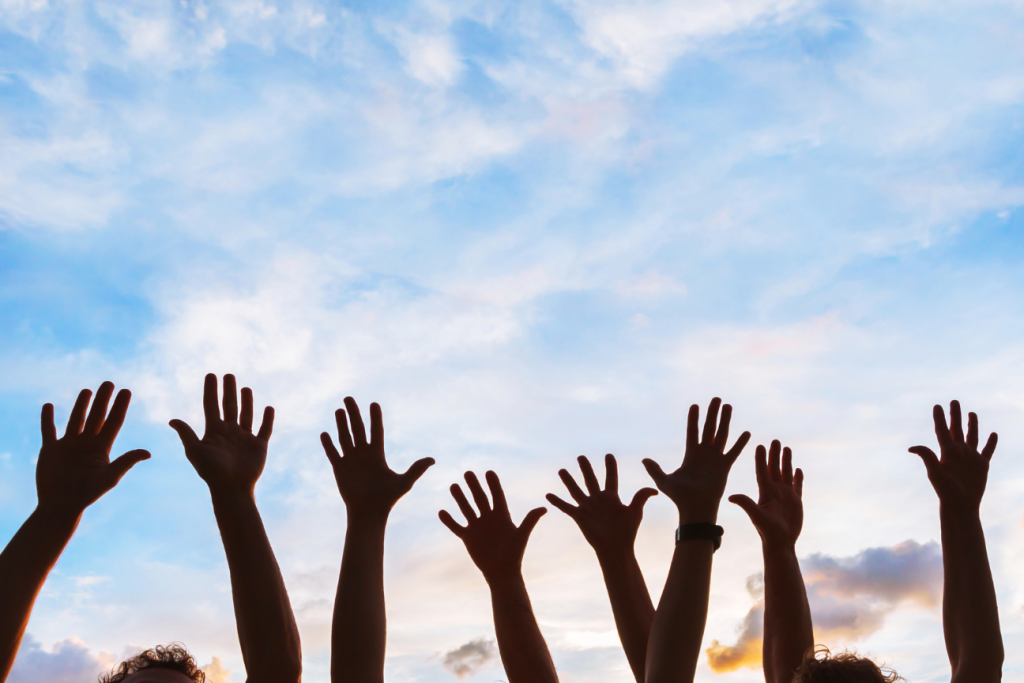 lots of peoples arms in the air 