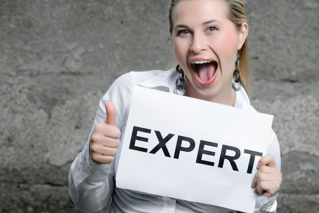 woman holding a sign that says expert